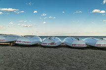 overturned lifeguard boats on a shore 