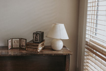 lamp on a console table and vintage camera 