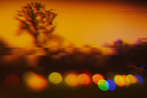 orange sky and bokeh colorful lights at sunset 