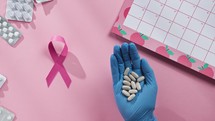 Doctor hand Holds Pills. Breast Cancer Awareness Month. 