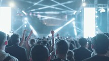 Unrecognizable People Crowd Dance and Hands Up at Evening Live Music Concert on Stage at Festival with Laser and Light in Slow Motion