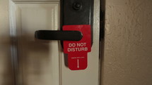 Hanging a do not disturb sign on a hotel room door