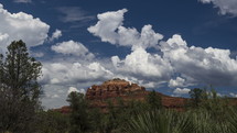 Timelapse of storm clouds building over a scenic sandstone butte