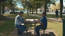 men's Bible study in a park 