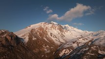 Scenic snowy mountain summit in Albania, birds eye view at sunset