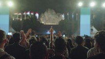 Unrecognizable People Crowd Dance and Hands Up at Evening Live Music Concert on Stage at Festival in Slow Motion