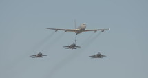 Military jets during an aerial refueling demonstration in an airshow.