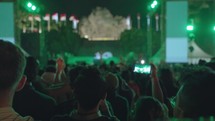 Unrecognizable People Crowd Dance and Hands Up at Evening Live Music Concert on Stage at Festival in Slow Motion