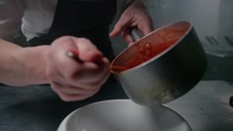 Chef Pouring Tomato Sauce For Plating 