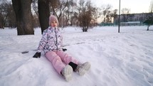 Child girl play in winter park Outdoor. Teen girl walks outdoors in cold winter. Carefree childhood. Portrait of charming girl outdoors.
