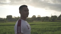 Portrait Asian Indonesian Male Hopeful Thoughtful and Confident Face Illuminated by The Sun in Dramatic Slow Motion