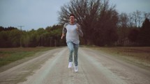 a man running down a rural road 