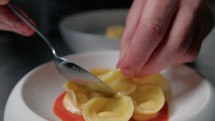 Chef Defining The Plating Of His Cappelletti Dish 