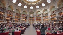 Paris, France - March 19, 2024: The Salle Ovale at the Bibliothèque Nationale de France, Richelieu an elegant oval room wood-paneled walls and beautiful ceiling, adorned with valuable book collection