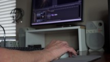 A man editing a video on a desktop computer