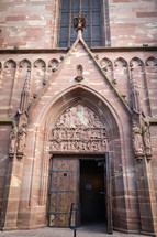 Door in stone Cathedral with statues