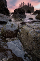 tide washing over rocks forming tide pools at sunset 