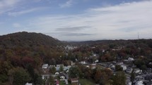 Drone over fall foliage and homes