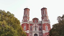 Panning in on the Shrine of St. Joseph Catholic Cathedral Church in Downtown Saint Louis, Missouri with green trees.