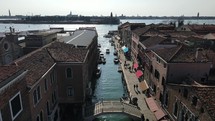 Aerial shot ascending up over a canal in Venice, Italy.