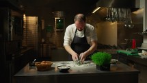 Chef Making The Dough With Flour Eggs And Squid Ink Food Into Restaurant
