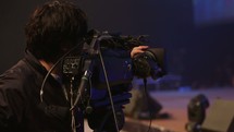 videographer filming a dancer on stage 