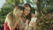 young women looking at social media an iPad screen 