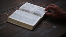 turning the pages of a Bible 