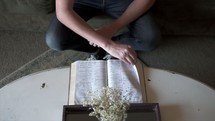 a man sitting down to read a Bible 