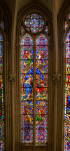  Stained glass windows Montpellier  church colorful designs and the way they cast colored light into the interior when sunlight shines through them. depict biblical scenes, saints, angels, and other religious symbols.