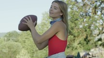 A young woman throwing a football 