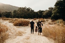 a family walking holding hands in a desert 