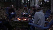 friends sitting by a campfire 