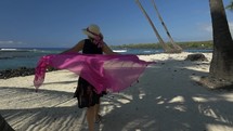 A woman walking on an exotic tropical beach