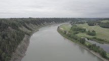 Drone shot of a river valley on an overcast day.