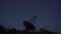 Timelapse of an array of large dish telescopes tracking the stars at night