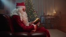 Santa Relaxing in his house reading a book