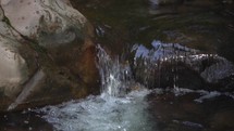 Water flowing in a mountain stream in slow motion