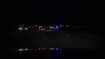 Passing a police car on the highway at night