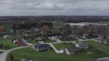 Aerial pullback of large homes in a rural Indiana neighborhood