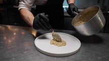 Chef prepares risotto with shrimps