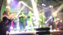 musicians in a band playing music on stage 