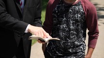 a man sharing the Bible with another 