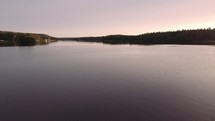 drone shot over a lake at sunset 