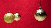 golden christmas balls rotate on red background