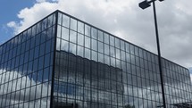 Timelapse of clouds and sky reflecting off of an office building