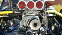 Close up of a race car engine revving 