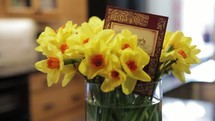 daffodils in a vase and a mother's day card 