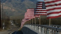 A highway bridge lined with American flags