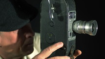 A man shooting a movie with a vintage 16mm camera